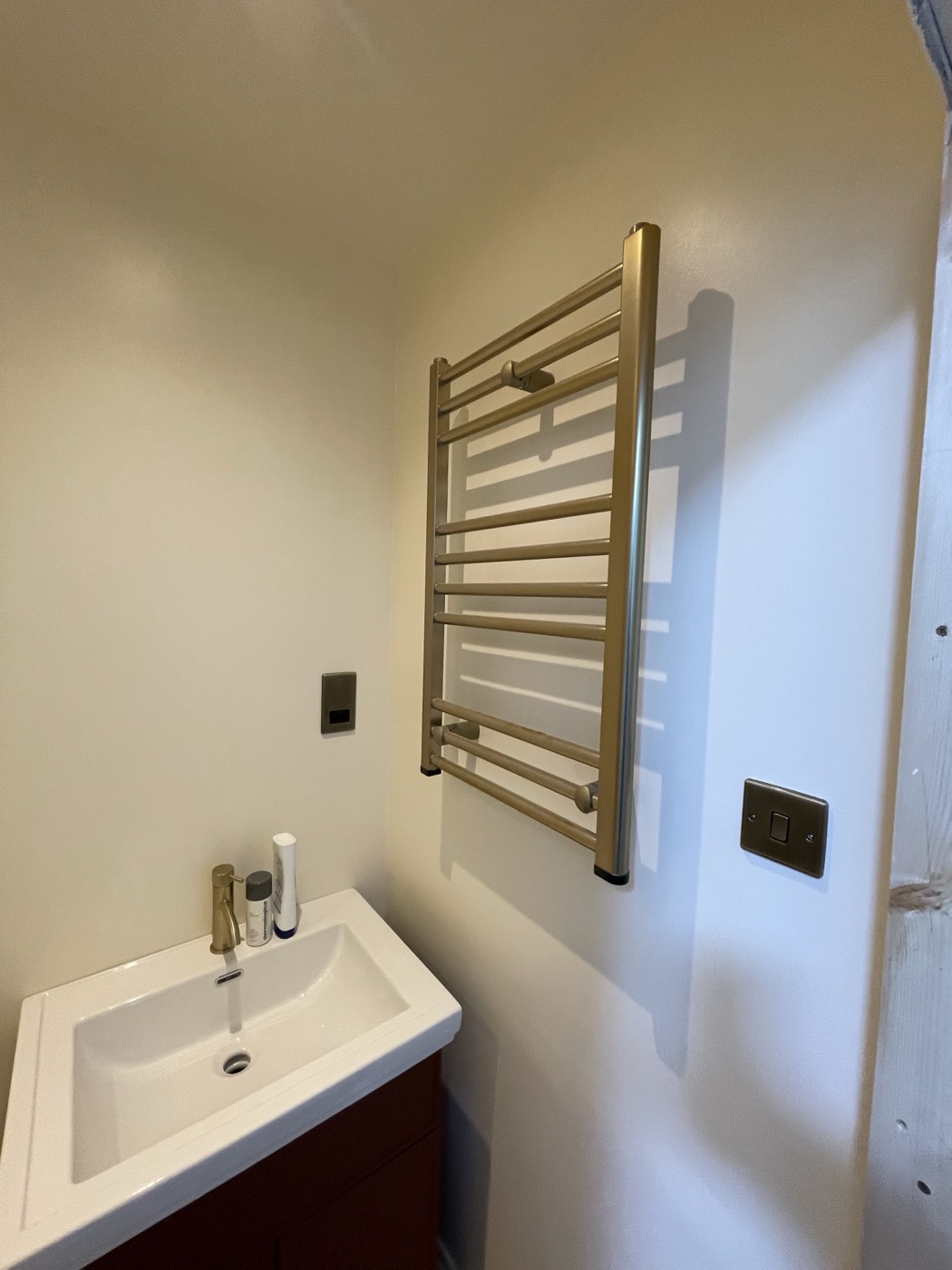 Basin and heated brass towel rail in a Mill Hill NW7 bathroom renovation