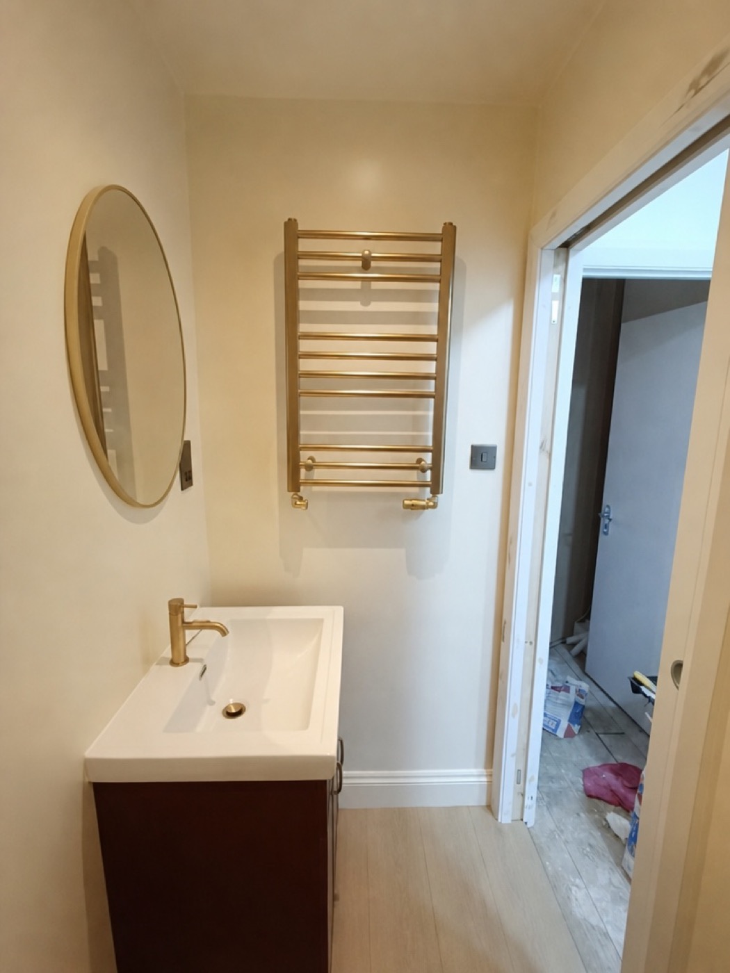 Vanity unit, round brass mirror and heated brass towel rail, Mill Hill NW7