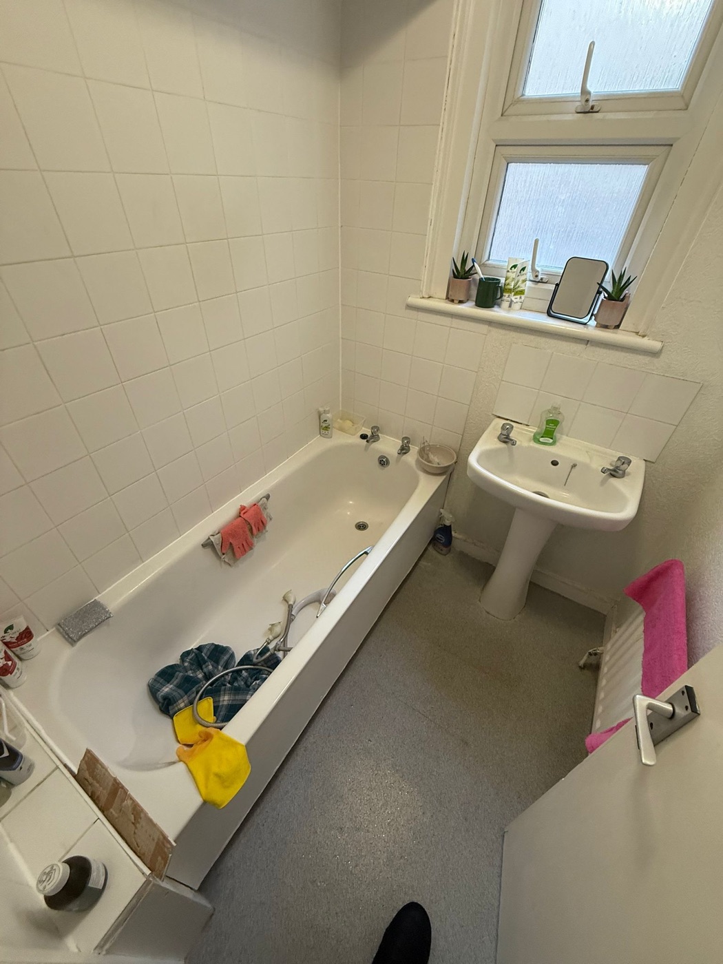 Streatham SW16 bathroom before renovation — dated white tiling and pedestal basin