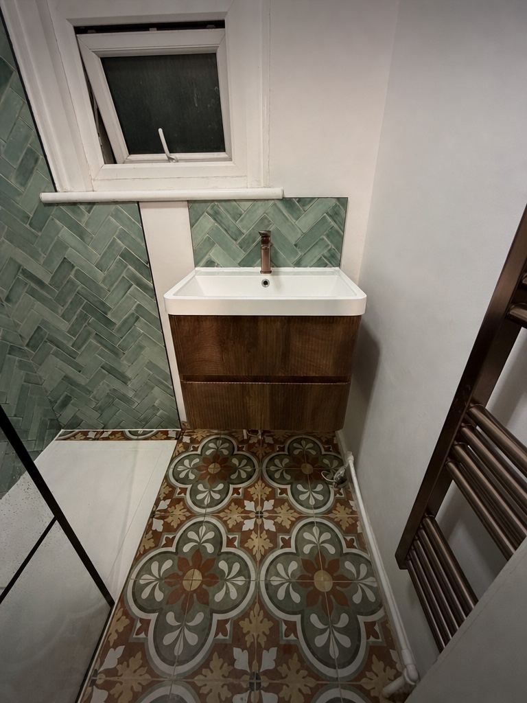Walnut vanity with copper tap and patterned encaustic floor tiles, Streatham SW16