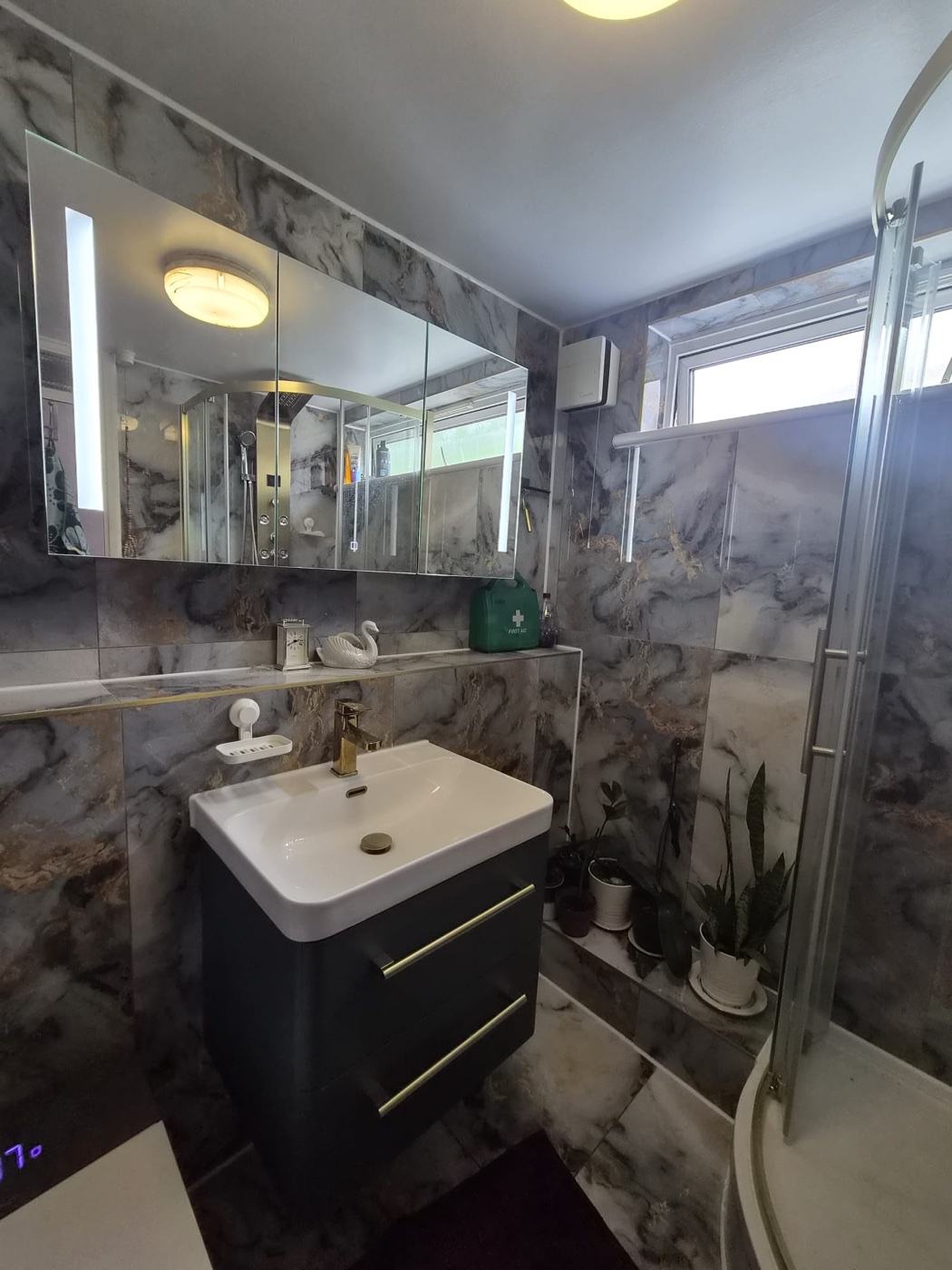 Wall-hung vanity with brass tap and illuminated mirror cabinet, Woolwich SE18